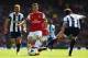 LONDON, ENGLAND - MAY 04: Mesut Ozil of Arsenal is tackled by Jonas Olsson of West Bromwich Albion during the Barclays Premier League match between Arsenal and West Bromwich Albion at the Emirates Stadium on May 4, 2014 in London, England. (Photo by Sha