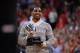 COLUMBUS, OH - FEBRUARY 19: Braxton Miller #5 of the Ohio State Buckeyes football team shows off his second consecutive Chicago Tribune Silver Football presented to him in the first half of the basketball game between Ohio State and the Northwestern Wild