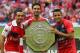 LONDON, ENGLAND - AUGUST 10: Mikel Arteta of Arsenal holds up the trophy next to Santi Cazorla (L) and Alexis Sanchez after the FA Community Shield match between Manchester City and Arsenal at Wembley Stadium on August 10, 2014 in London, England. (Phot