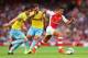 LONDON, ENGLAND - AUGUST 16: Alexis Sanchez of Arsenal goes past Joel Ward (L) and Joe Ledley of Crystal Palace during the Barclays Premier League match between Arsenal and Crystal Palace at Emirates Stadium on August 16, 2014 in London, England. (Photo