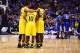 INDIANAPOLIS, IN - MARCH 30: Jordan Morgan #52, Derrick Walton Jr. #10 and Caris LeVert #23 of the Michigan Wolverines huddle with their team before their midwest regional final against the Kentucky Wildcats part of the 2014 NCAA Men's Basketball Tournam
