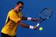 MELBOURNE, AUSTRALIA - JANUARY 19: Oscar Hernandez of Germany plays a backhand in his first round match against Albert Montanes of Spain during day two of the 2010 Australian Open at Melbourne Park on January 19, 2010 in Melbourne, Australia. (Photo by