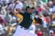Leon pitching for the A's in spring training 2014.
