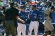 TORONTO, CANADA - AUGUST 24: Jose Bautista #19 of the Toronto Blue Jays reacts after being ejected by home plate umpire Bill Welke #52 for arguing a called third strike as manager John Gibbons #5 comes out to restrain him in the sixth inning during MLB ga