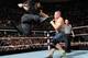 Roman Reigns hits John Cena with the Superman punch.