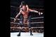 Roman Reigns tries to put Randy Orton out with a sleeper hold.