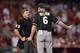 Aug 28, 2014; Anaheim, CA, USA; Oakland Athletics manager Bob Melvin talks with home plate umpire Greg Gibson after Los Angeles Angels shortstop Erick Aybar (not pictured) is called safe at first after a collision during the ninth inning at Angel Stadium