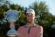 NORTON, MA - SEPTEMBER 01: Chris Kirk is presented with the winner's trophy after winning the Deutsche Bank Championship at the TPC Boston on September 1, 2014 in Norton, Massachusetts. (Photo by Ross Kinnaird/Getty Images)