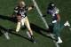 BOULDER, CO - OCTOBER 05: Quarterback Connor Wood #5 of the Colorado Buffaloes scramble to elude defensive end Tony Washington #91 of the Oregon Ducks at Folsom Field on October 5, 2013 in Boulder, Colorado. The Ducks defeated the Buffs 57-16. (Photo by