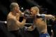 May 24, 2014; Las Vegas, NV, USA; TJ Dillashaw (blue) throws a punch at Renan Barao (red) during their UFC 173 bantamweight championship bout at MGM Grand Garden Arena. Dillashaw won the bout by way of TKO. Mandatory Credit: Stephen R. Sylvanie-USA TOD
