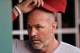 CINCINNATI, OH - JULY 29: Manager Kirk Gibson #23 of the Arizona Diamondbacks looks over the lineup in the dugout before a game against the Cincinnati Reds at Great American Ball Park on July 29, 2014 in Cincinnati, Ohio. (Photo by Jamie Sabau/Getty Ima