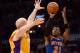 LOS ANGELES, CA - MARCH 25: Iman Shumpert #21 of the New York Knicks shoots over the hands of Chris Kaman #9 of the Los Angeles Lakers at Staples Center on March 25, 2014 in Los Angeles, California. NOTE TO USER: User expressly acknowledges and agrees