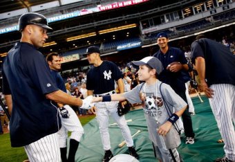 NEW YORK - JUNE 30: NY Yankee Derek Jeter and Ben Grant - 10 year old boy from Starlight Foundation attend NY Yankee batting practice at Yankee Stadium on June 30, 2009 in New York City. (Photo by Joe Kohen/Getty Images for Iconix Brand Group, Inc)