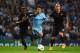 MANCHESTER, ENGLAND - SEPTEMBER 30: Radja Nainggolan and Mapou Yanga-Mbiwa (L) of AS Roma challenge David Silva of Manchester City during the UEFA Champions League Group E match between Manchester City FC and AS Roma on September 30, 2014 in Manchester,