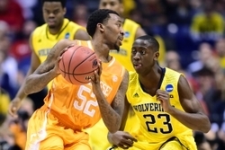 Mar 28, 2014; Indianapolis, IN, USA; Tennessee Volunteers guard Jordan McRae (52) controls the ball against Michigan Wolverines guard Caris LeVert (23) in the second half in the semifinals of the midwest regional of the 2014 NCAA Mens Basketball Champions