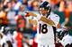 EAST RUTHERFORD, NJ - OCTOBER 12: Peyton Manning #18 of the Denver Broncos yells to teammates in the second quarter during a game against the New York Jets at MetLife Stadium on October 12, 2014 in East Rutherford, New Jersey. (Photo by Jeff Zelevansky/