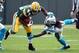 Oct 19, 2014; Green Bay, WI, USA; Green Bay Packers running back James Starks (44) tries to avoid a tackle by Carolina Panthers safety Charles Godfrey (30) in the first quarter at Lambeau Field. Mandatory Credit: Benny Sieu-USA TODAY Sports