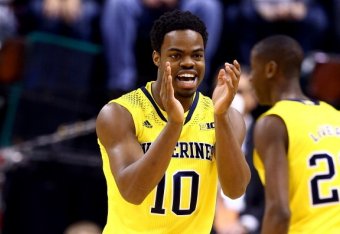INDIANAPOLIS, IN - MARCH 16:  Derrick Walton Jr. #10 of the Michigan Wolverines reacts against the Michigan State Spartans during the 2014 Big Ten Men's Championship at Bankers Life Fieldhouse on March 16, 2014 in Indianapolis, Indiana.  (Photo by Andy Ly