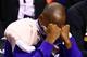 Oct 29, 2014; Phoenix, AZ, USA; Los Angeles Lakers guard Kobe Bryant reacts as he wears an ice pack on his right shoulder as he sits on the bench prior to the game against the Phoenix Suns during the home opener at US Airways Center. The Suns defeated the