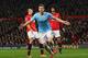 MANCHESTER, ENGLAND - MARCH 25: Edin Dzeko of Manchester City celebrates scoring the second goal during the Barclays Premier League match between Manchester United and Manchester City at Old Trafford on March 25, 2014 in Manchester, England. (Photo by A