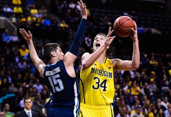 NEW YORK, NY - NOVEMBER 25:  Mark Donnal #34 of the Michigan Wolverines attempts a shot over Ryan Arcidiacono #15 of the Villanova Wildcats in the first half at the Barclays Center on November 25, 2014 in the Brooklyn borough of New York City.  (Photo by 
