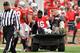COLUMBUS, OH - NOVEMBER 29: Quarterback J.T. Barrett #16 of the Ohio State Buckeyes is comforted by Jacoby Boren #50 of the Ohio State Buckeyes as Barrett is taken off the field after injuring his leg in the fourth quarter against the Michigan Wolverines