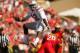 COLLEGE PARK, MD - OCTOBER 04: Quarterback Cardale Jones #12 of the Ohio State Buckeyes hurdles safety Anthony Nixon #20 of the Maryland Terrapins during the fourth quarter of Ohio State's 52-24 win at Byrd Stadium on October 4, 2014 in College Park, Mar