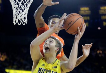 ANN ARBOR, MI - DECEMBER 2: Mark Donnal #34 of the Michigan Wolverines goes to the basket past Chris McCullough #5 of the Syracuse Orange during the first half at Crisler Arena on December 2, 2014 in Ann Arbor, Michigan. (Photo by Duane Burleson/Getty Im