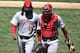 SAN DIEGO, CA - JULY 2: Johnny Cueto #47 of the Cincinnati Reds (L) walks back to the dugout with Brayan Pena #29 at the end of the seventh inning of a baseball game against the San Diego Padres at Petco Park July 2, 2014 in San Diego, California. The P