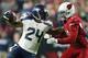 GLENDALE, AZ - DECEMBER 21: Running back Marshawn Lynch #24 of the Seattle Seahawks pushes off cornerback Patrick Peterson #21 of the Arizona Cardinals to run in a 79 yard touchdown in the fourth quarter during the NFL game at the University of Phoenix S