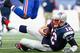 FOXBORO, MA - DECEMBER 28: Tom Brady #12 of the New England Patriots slides with the ball during the second quarter against the Buffalo Bills at Gillette Stadium on December 28, 2014 in Foxboro, Massachusetts. (Photo by Jared Wickerham/Getty Images)