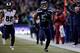 SEATTLE, WA - DECEMBER 28: Outside linebacker Bruce Irvin #51 of the Seattle Seahawks runs an interception back 49 yards for a touchdown as tight end Lance Kendricks #88 of the St. Louis Rams gives chase during the fourth quarter of the game against the S