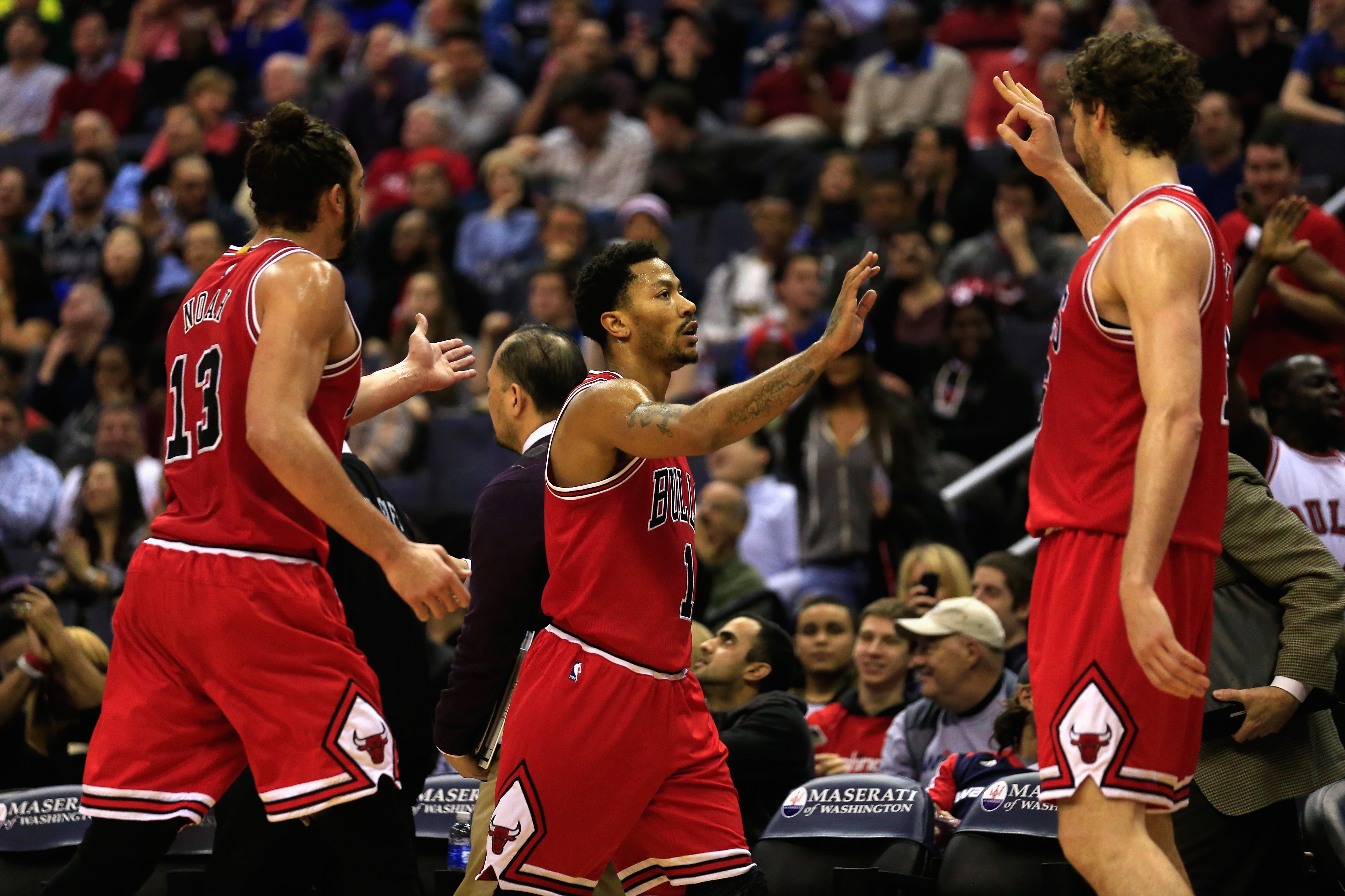 WASHINGTON, DC - DECEMBER 23: Derrick Rose #1 of the Chicago Bulls (C) celebrates after hitting a shot to end the first half with teammates Joakim Noah #13 and Pau Gasol #16 against the Washington Wizards at Verizon Center on December 23, 2014 in Washingt