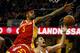CLEVELAND, OH - JANUARY 7: Kevin Love #0 of the Cleveland Cavaliers is fouled as he shoots against Josh Smith #5 and Dwight Howard #12 of the Houston Rockets during the second half of their game on January 7, 2015 at Quicken Loans Arena in Cleveland, Oh
