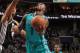 CHARLOTTE, NC - JANUARY 14: Lance Stephenson #1 of the Charlotte Hornets shoots against Tim Duncan #21 of the San Antonio Spurs during the game at the Time Warner Cable Arena on January 14, 2015 in Charlotte, North Carolina. NOTE TO USER: User expressly