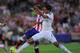 MADRID, SPAIN - AUGUST 22: Mario Mandzukic of Club Atletico de Madrid beats Raphael Varane of Real Madrid to score his team's opening goal during the Supercopa, second leg match between Club Atletico de Madrid and Real Madrid at Vicente Caldron stadium o