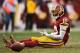 LANDOVER, MD - DECEMBER 28: Quarterback Robert Griffin III #10 of the Washington Redskins reacts after throwing a fourth quarter interception against the Dallas Cowboys at FedExField on December 28, 2014 in Landover, Maryland. The Dallas Cowboys won, 44-1