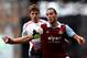 LONDON, ENGLAND - APRIL 06: Andy Carroll of West Ham controls the ball as Jon Flanagan of Liverpool closes during the Barclays Premier League match between West Ham United and Liverpool at Boleyn Ground on April 6, 2014 in London, England. (Photo by Mik