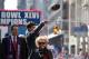 NEW YORK, NY - FEBRUARY 07: Quarterback Eli Manning #10 (C) of the New York Giants throws back a football that was thrown to him as New York Gov. Andrew Cuomo (L) and Ann Mara looks on during the Giants' Victory Parade on February 7, 2012 in New York Cit