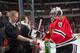CHICAGO, IL - FEBRUARY 09: Goalie Corey Crawford #50 of the Chicago Blackhawks has his stick checked out by assistant equipment manager Jim Heintzelman prior to the NHL game against the Arizona Coyotes at the United Center on February 9, 2015 in Chicago,