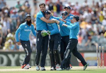 PERTH, AUSTRALIA - FEBRUARY 01:  Jos Buttler of England is mobbed by teammates Steven Finn and Eoin Morgan after running out Mitchell Marsh of Australia during the final match of the Carlton Mid One Day International series between Australia and England a