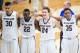 Jan 17, 2015; South Bend, IN, USA; Notre Dame Fighting Irish forward Zach Auguste (30) guard Jerian Grant (22) guard Pat Connaughton (24) and forward Bonzie Colson (35) sing the Notre Dame alma mater after defeating the Miami Hurricanes 75-70 at the Purce