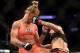LOS ANGELES, CA - FEBRUARY 28: (R) Raquel Pennington punches Holly Holm in their women's bantamweight bout during the UFC 184 event at Staples Center on February 28, 2015 in Los Angeles, California. (Photo by Harry How/Getty Images)