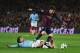 BARCELONA, SPAIN - MARCH 18: David Silva of Manchester City tackles Lionel Messi of Barcelona during the UEFA Champions League Round of 16 second leg match between Barcelona and Manchester City at Camp Nou on March 18, 2015 in Barcelona, Spain. (Photo b