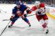 UNIONDALE, NY - DECEMBER 29: Jay Beagle #83 of the Washington Capitals in action against Lubomir Visnovsky #11 of the New York Islanders on December 29, 2014 at Nassau Veterans Memorial Coliseum in Uniondale, New York. The Islanders defeat the Capitals 4-