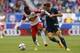 Apr 26, 2015; Harrison, NJ, USA; New York Red Bulls midfielder Lloyd Sam (10) controls the ball against Los Angeles Galaxy midfielder Robbie Rogers (14) during second half at Red Bull Arena. Final score 1-1. Mandatory Credit: Noah K. Murray-USA TODAY Spo