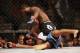 Jul 16, 2014; Atlantic City, NJ, USA; Aljamain Sterling (blue gloves) lands a punch on Hugo Viana (red gloves) during a bantamweight bout at Revel Casino. Mandatory Credit: Bill Streicher-USA TODAY Sports