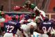 As a Barcelona Dragon, Lawrence Phillips vaults over the line of the Frankfurt Galaxy in an NFL Europe game in June 1999.