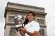 Roger Federer poses with the 2009 French Open trophy in front of the Champs-Elysées in Paris.