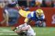 ARLINGTON, TX - SEPTEMBER 13: Paul Perkins #24 of the UCLA Bruins is tackled by Quandre Diggs #6 of the Texas Longhorns in the first quarter at AT&T Stadium on September 13, 2014 in Arlington, Texas. (Photo by Ronald Martinez/Getty Images)